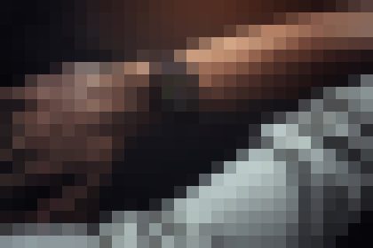 Heavily pixelated image with dark brown tones on top and gray blocks toward the bottom; no discernible subject or detail.