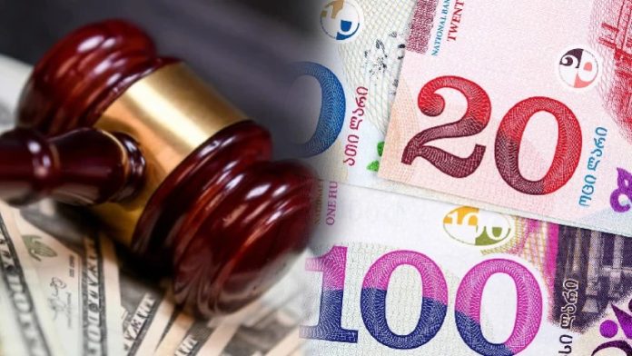 Judicial gavel resting on piles of cash, conveying a legal ruling related to money/assets.